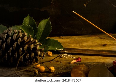 still life with traditional broom, incense, pine cones, red rose petals - Powered by Shutterstock