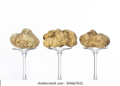 Still life of a truffles placed on the pedestal in glass on the white background