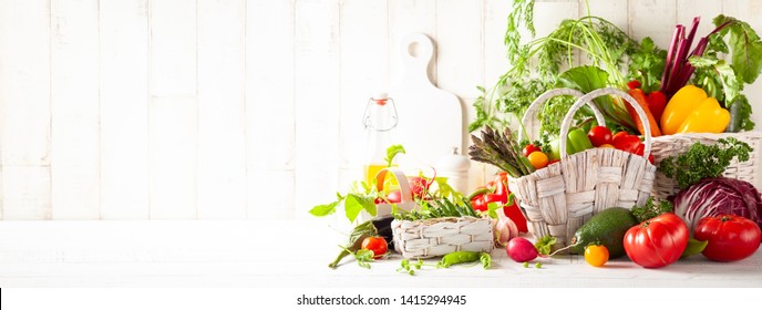 Still life with various types of fresh vegetables in baskets on a white wooden table. Concept of healthy eating, fresh vegetables. - Powered by Shutterstock