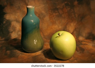 Still life with vase and apple over abstract background