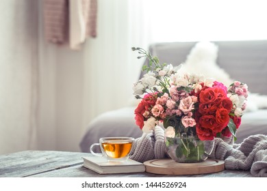 Still Life Of A Vase With Roses In The Living Room. The Concept Of Home Comfort.