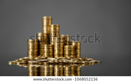 still life of very many rouleau gold  monetary or change coin, on grey background