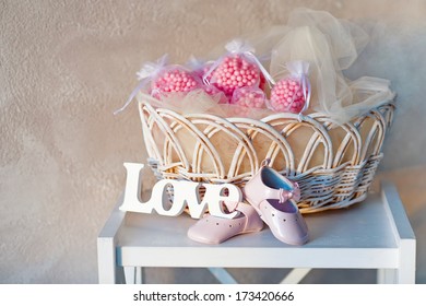 Still Life With Wooden Love Letters, Baby's Shoes And Wicker Basket