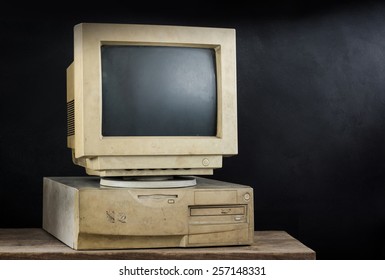 still photography : old and obsolete computer on old wood with art dark background