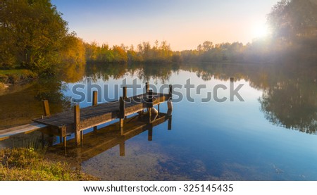 Still waters reflect the wooden piers Lake at Sunset