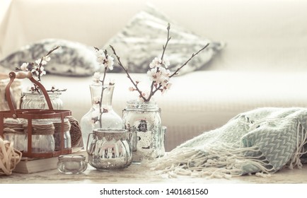 Still-life. Home Cozy Beautiful Decor In The Living Room, Vases With Spring Flowers, On The Background Of A Wooden Table, Interior Details