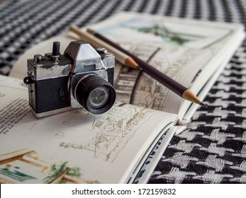 Still-life Of Toy Camera On Open Sketch Book