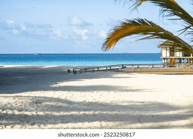 Stilt house with wooden walkway to the beach in a tourist resort - Powered by Shutterstock