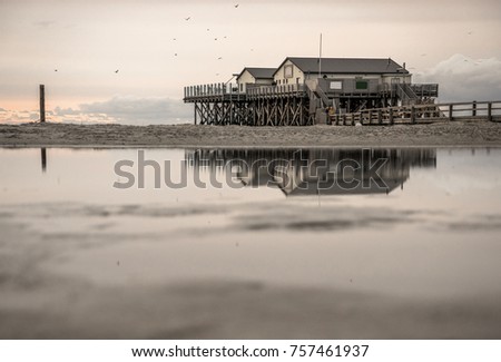 stilt houses in St. Peter-Ording; Germany/ reflection in the eve
