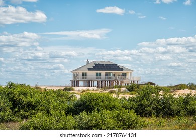 Stilted vacation house on stilts at oceanfront waterfront of Atlantic ocean beach at Crescent Beach in the Palm Coast of Florida for hurricane protection and solar panels on sunny day