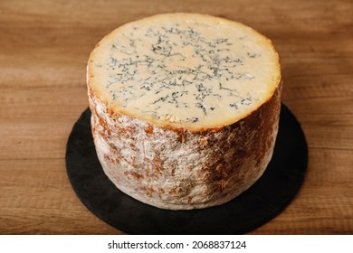 Stilton cheese on a rustic background