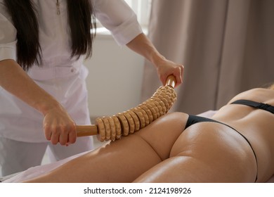 Stimulation lymphatic system with wood therapy treatment. Massage with wooden roller to eliminate liquids and cellulite. Improve circulation in the legs. Aesthetic tools