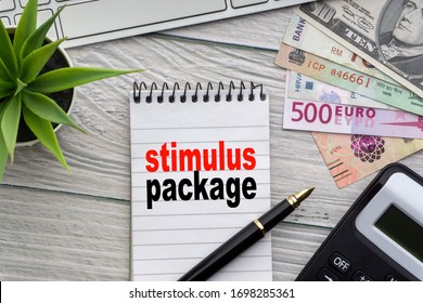 STIMULUS PACKAGE Text With Notepad, Keyboard, Decorative Vase, Fountain Pen, Calculator And Banknotes Currency On Wooden Background. Business And Copy Space Concept