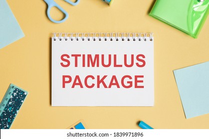 STIMULUS PACKAGE Text With Notepad, Keyboard, Decorative Vase, Fountain Pen, Calculator And Banknotes Currency On Wooden Background. Business And Copy Space Concept