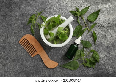 Stinging Nettle, Extract And Comb On Grey Background, Flat Lay. Natural Hair Care