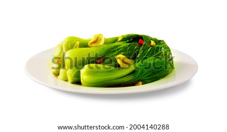 Stir fried bok choy with soy sauce on plate and chopsticks on white background, Asian vegan food, Side view