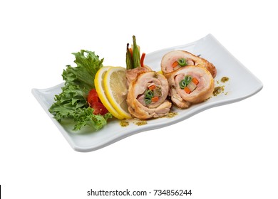 Stir fried chicken wrap with carrot. scallion and radish served with sliced lemon, tomato and lettuce in white ceramic plate.