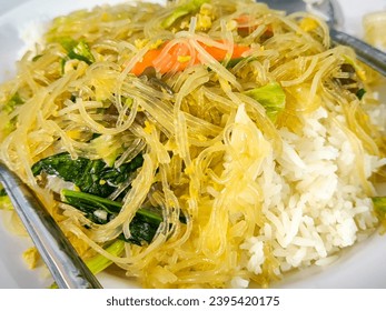 Stir fried Korean glass noodle with soy sauce called Japchae and rice - Shutterstock ID 2395420175