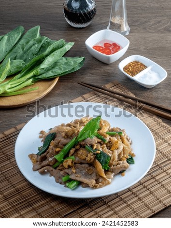 stir fried large noodles with soy sauce, dish of PAD SEE EW