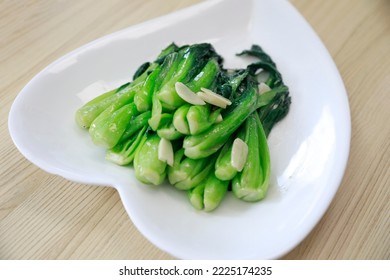 Stir fried small green vegetables is a traditional delicacy. - Shutterstock ID 2225174235