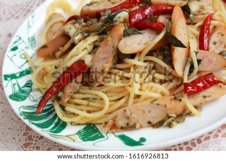 Stir fried spaghetti with sausage and garlic and clear dry prim