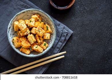 Stir Fried Tofu in a bowl with sesame and greens. Homemade healthy vegan asian meal - fried tofu. - Shutterstock ID 708811618
