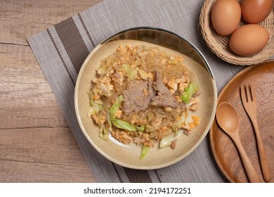 Stir Fried Vermicelli With Pork, Egg And Collard Greens In A White Plate.