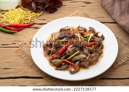 Stir Fry chicken liver with Ginger,Fried sliced ginger and liver with ear mushroom, onion, spring onion and chilli in white plate