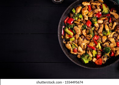 Stir Fry With Chicken, Mushrooms, Broccoli And Peppers. Chinese Food. Top View, Overhead