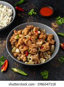 Stir Fry Chinese Salt And Pepper Chicken With Rice In Grey Bowl