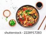Stir fry egg noodles with chicken, sweet paprika, mushrooms, chives and sesame seeds in bowl. Asian cuisine dish. White table background, top view