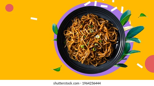 Stir fry noodles with vegetables and shrimps in black bowl. Japanese soba salad with vegetables. Bowl of soba noodles with beef. Asian food. Indo-Chinese cuisine hot dish with udon noodles. 