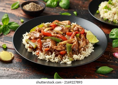 Stir fry pepper chicken with sweet peppers, onion, garlic and ginger - Shutterstock ID 2169227893