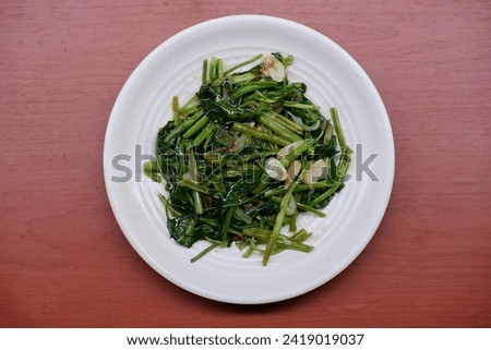Stir fry water morning glory or stir-fry water spinach in Indonesia known as cah kangkung or tumis kangkung 