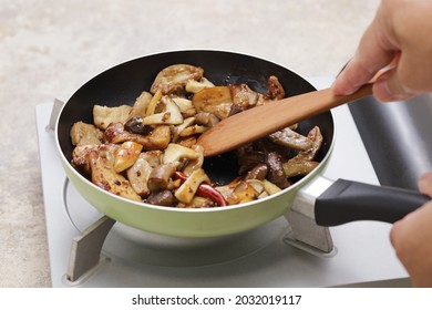 stir frying porcini mushrooms in a fry pan
