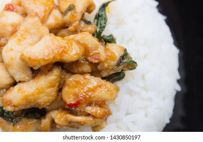 Stir-Fried Chicken And Holy Basil On Rice Or Thai Food Recipe Flatlay Left Frame. Stir-Fried Chicken And Holy Basil With White Rice On Black Dish