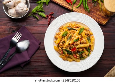 Stir-Fried Minced pork and Basil with Penne rigate pasta,Pad Kra Pao,Thai fusion food.Top view