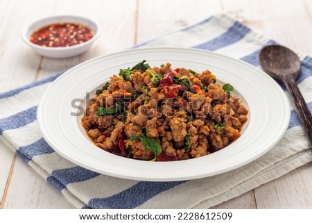 Stir-fried minced pork with holy basil leaves or pad kra pao moo, a simple-easy-delicious Thai hot dish served diners from street food carts to restaurants in Thailand.