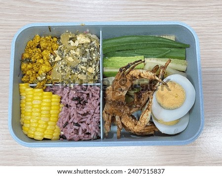 Stir-fried pickled cabbage with egg, small crab fried in batter, boiled egg, boiled vegetables and rice and corn