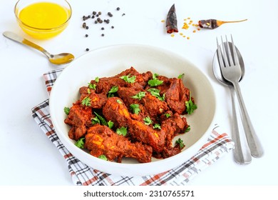 Stir-Fried Spicy Indian Chicken Garnished with Cilantro Low Angle Close Up Photo - Shutterstock ID 2310765571