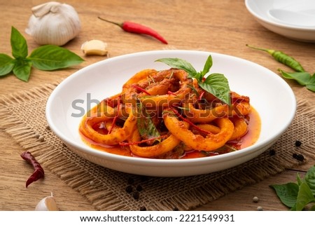 Stir-Fried Squid with Red Curry Paste in white plate.Thai spicy food