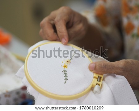 Stitches in hand woman Embroidery Flowers Handmade Art with Simple Stitches