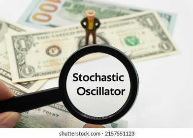 Stochastic Oscillator.Magnifying glass showing the words.Background of banknotes and coins.basic concepts of finance.Business theme.Financial terms.