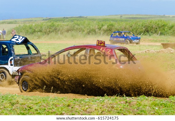 stock car racing along muddy\
track