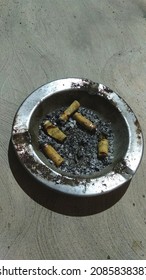 stock cigarette butts in the ashtray at night