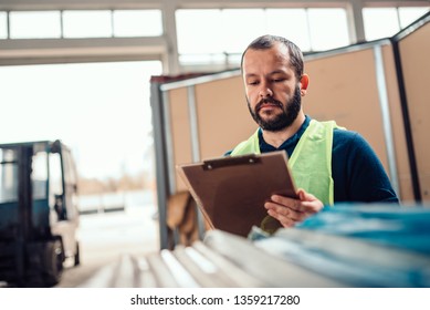 Stock clerk checking inventory in the warehouse of industrial factory - Powered by Shutterstock