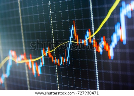 Stock diagram on the screen. Display of quotes pricing graph visualization. Stock market chart, graph on blue background. Shallow DOF. Stock market graph on the screen. 
