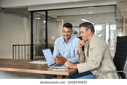 Stock exchange market traders investors working on financial trading charts analysis. Two happy busy business men analysts consulting on digital finance forecast using laptop in office. Copy space. - Powered by Shutterstock