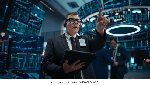 Stock Exchange Professional Communicating in an Open Outcry Method on a Trading Floor. Stylish Man Shouting and Using Hand Signals to Transfer Information About Buy and Sell Orders to Broker - Powered by Shutterstock