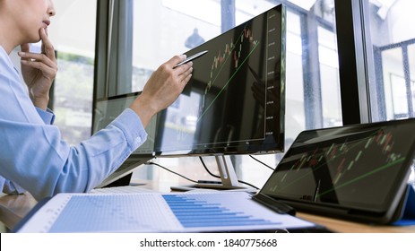 stock exchange trader working  with graphs,diagrams on monitor in modern trading office. - Shutterstock ID 1840775668